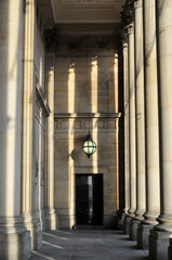 stone columns and portico of leeds town hall in west yorkshire in afternoon sunlight