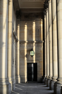 stone columns and portico of leeds town hall in west yorkshire in afternoon sunlight