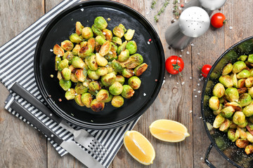 Plate with roasted brussel sprouts on table