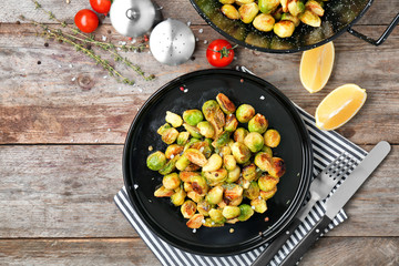 Plate with roasted brussel sprouts on table