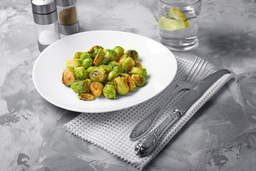 Plate with roasted brussel sprouts on table