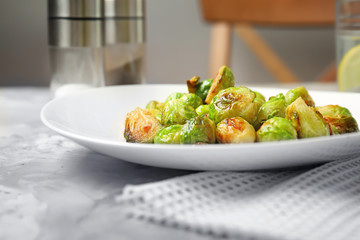 Plate with roasted brussel sprouts on table