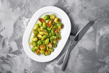 Plate with roasted brussel sprouts on table