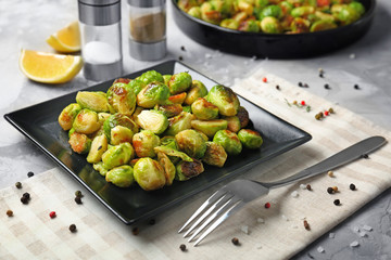 Plate with roasted brussel sprouts on table