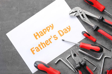 Set of tools with greeting card on grunge background. Father's Day concept