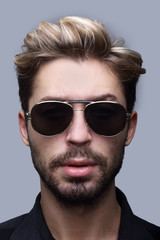 Close-up portrait of handsome stylish man in sunglasses.