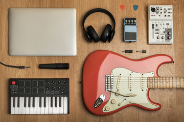 Various home studio objects and audio on wooden table