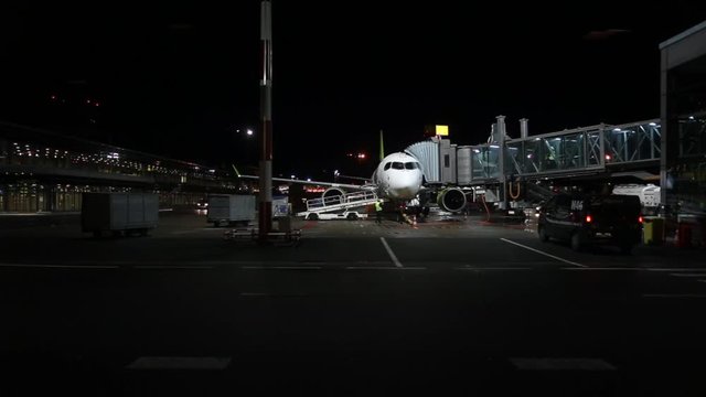 Night loading Luggage into a passenger plane