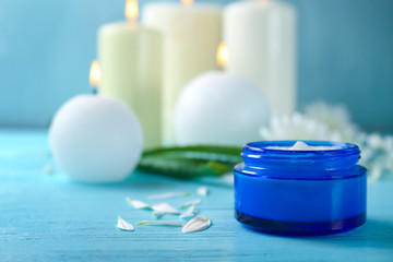 Jar with body cream on wooden table