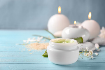 Jar with body cream on wooden table