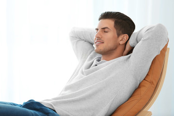 Happy young man relaxing at home