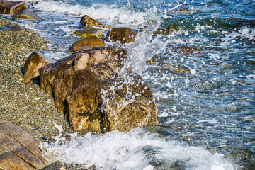 Scenic water splash and a rock in ocean