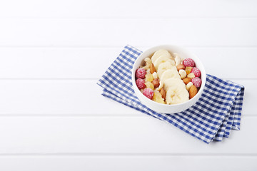 Healthy vegetarian cereal breakfast. Smoothie bowl with berries and nuts.