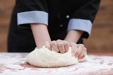 the cook makes flour for baking on the table