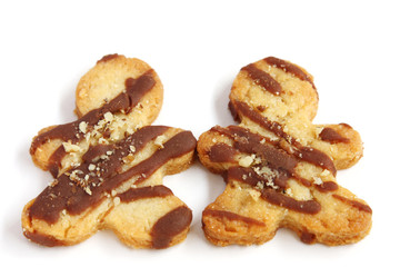 isolated couple of man shape cookies with chocolate and nuts with copy space, simbol of love