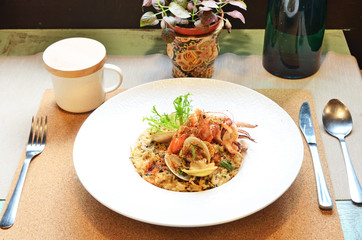 Italian seafood rice on white plate