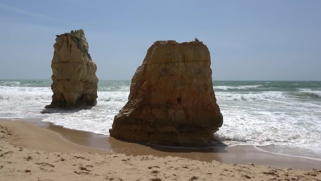 Amazing rock and sandy ocean beach 