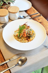 Italian seafood rice on white plate