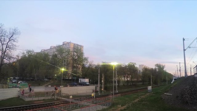 crossing the railway and trains at spring sunset timelapse