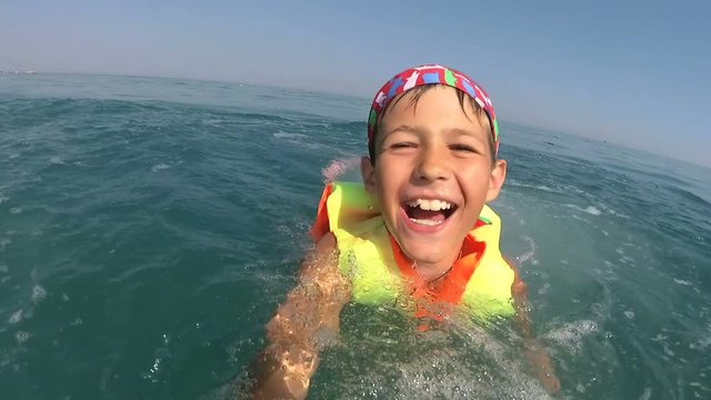 boy on pedal boat pulls off the hill into the sea