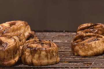 Cinnamon Buns Cooling on a Rack 