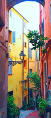 Narrow medieval, old street with flowers in San Remo, Liguria, Italy