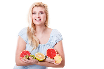 Woman holding fruits kiwi. orange, lemon and grapefruit