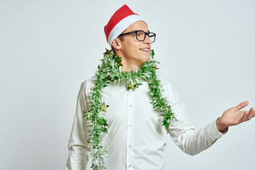 a young man with glasses, a white shirt and a green tinsel around his neck, a light background, a new year, a Christmas, a holiday