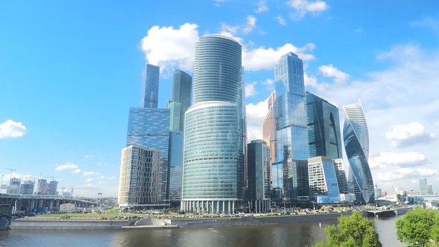 modern glass skyscrapers on the river bank in summer timelapse