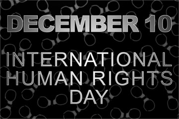 Human rights concept: handcuffs and the text: Human rights day written on blackboard.
