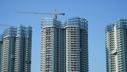 Fototapeta na wymiar skyscraper building under construction with crane at construction site