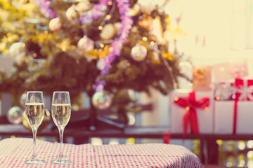 Naklejka na ściany i meble Christmas and Happy new year anniversary party holiday with sparkler wine in beautiful champagne glasses and christmas tree as background