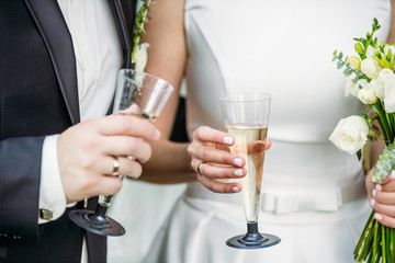 Newlyweds with champagne in their hands