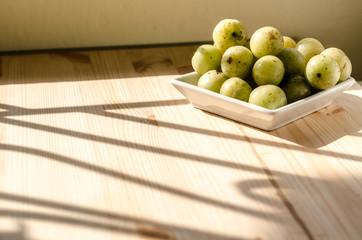 Indian Gooseberry: berry of high vitamin-c on the wooden background