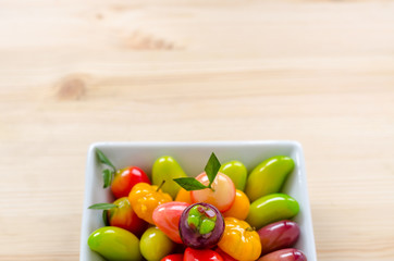 Thai dessert: deletable imitation fruits on the wooden background