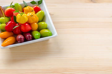 Thai dessert: deletable imitation fruits on the wooden background