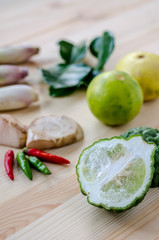 Herb ingredient of Tom Yum spicy soup Thai food cuisine on wooden background