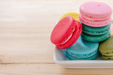 Colorful macaroons on wooden table background