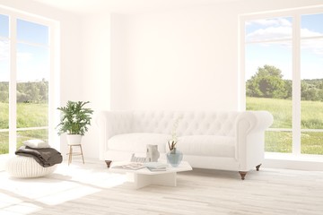 Fototapeta premium Idea of white room with sofa and summer landscape in window. Scandinavian interior design. 3D illustration