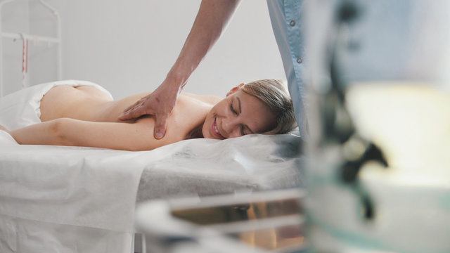 Bank with medical leeches against the massage for blonde girl