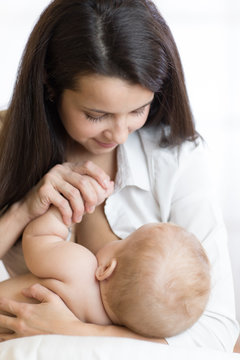young mother breast feeding newborn baby