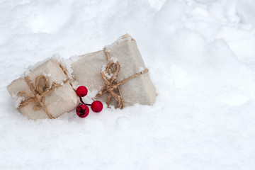 Fototapeta na wymiar gift box with mistletoe in fresh snow against a background
