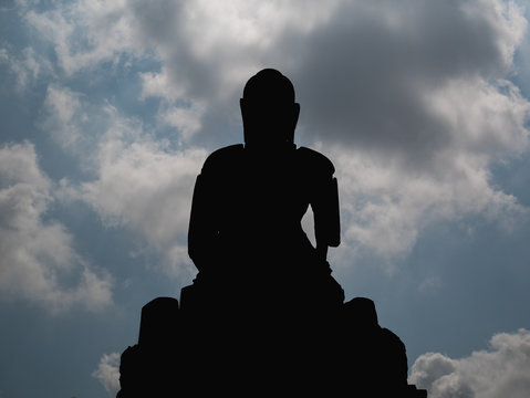 Silhouette of Buddha with blue sky