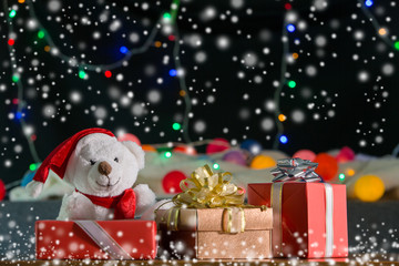 New year gifts with shining light and snow background
