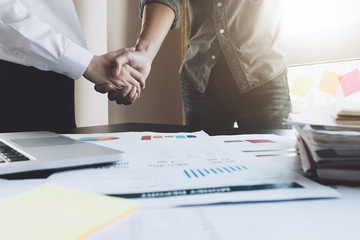 Business and partnership meeting concept. Image of young businessman handshake. Successful businessmen handshaking after good deal in his office