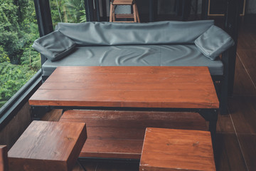 Coffee wooden chair and table with sofa in cozy lounge space,loft style