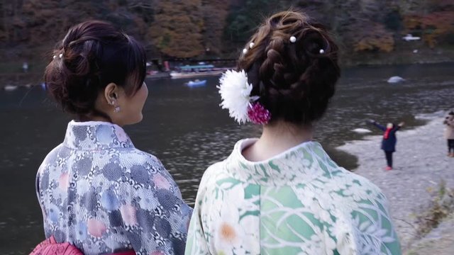 Kimono women in buys tourist spot near Kyoto river.
