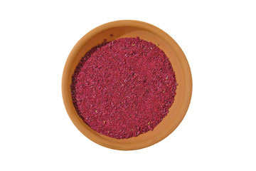 dried sumac in a bowl isolated on white