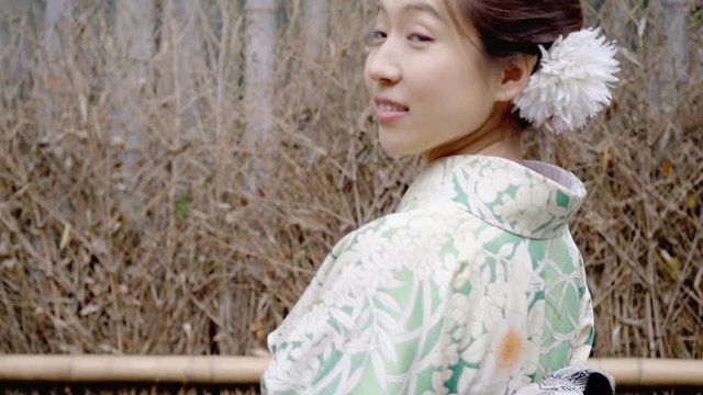 Pretty Japanese woman smiling in her Kimono.