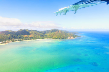 Aerial view of Mahe, maine island of Seychelles, with part of airplane wing
